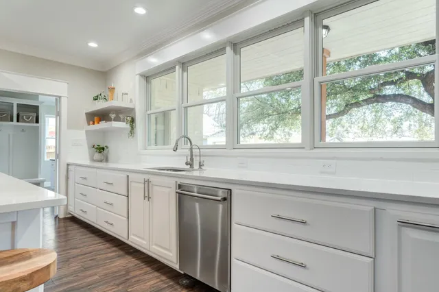 a kitchen with sink cabinets and window