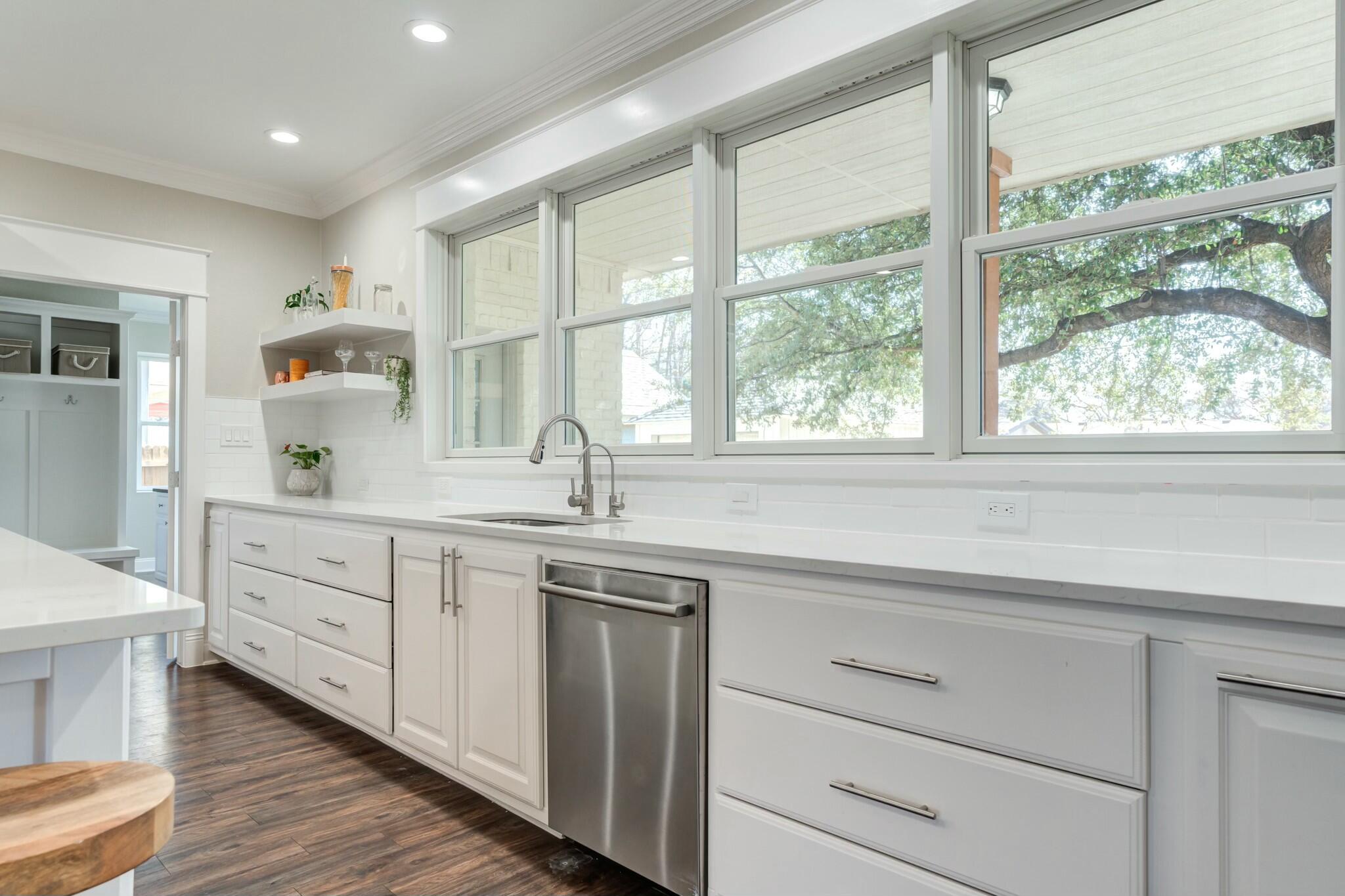 3219 22nd Street Lubbock, TX 79410 - Photo 13 of 51 a kitchen with sink cabinets and window