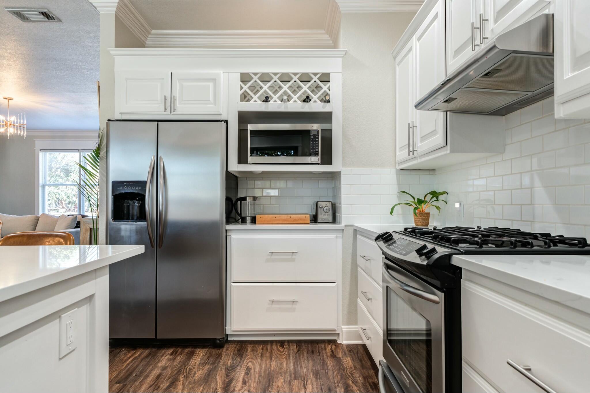3219 22nd Street Lubbock, TX 79410 - Photo 18 of 51 a kitchen with stainless steel appliances granite countertop a stove and a refrigerator