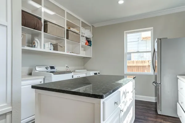 a kitchen with a center island cabinets and wooden floor
