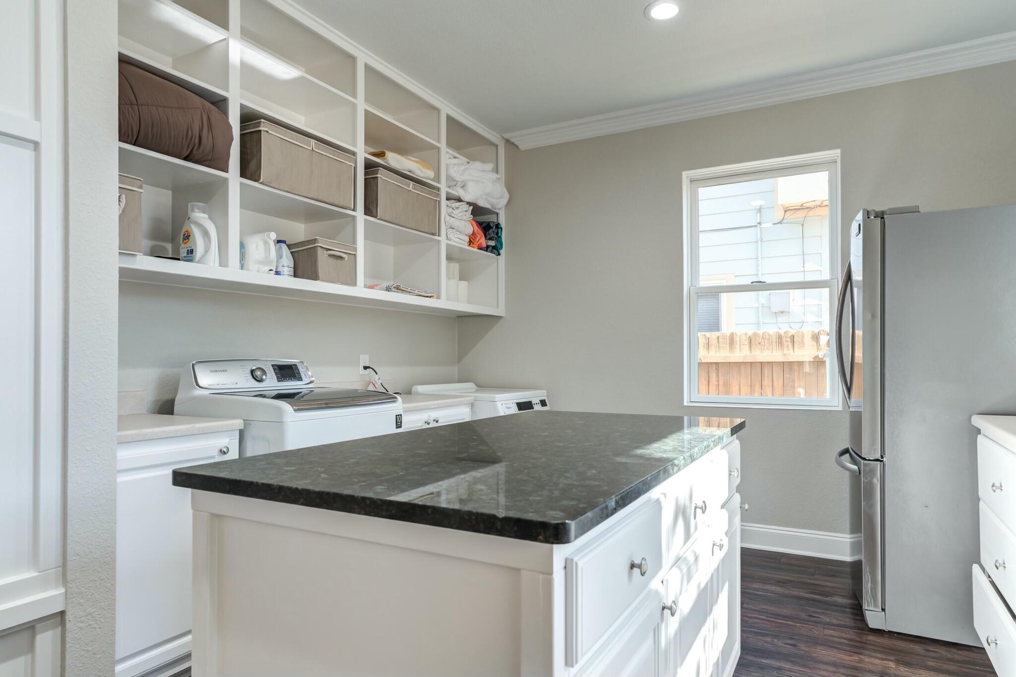 3219 22nd Street Lubbock, TX 79410 - Photo 22 of 51 a kitchen with a center island cabinets and wooden floor