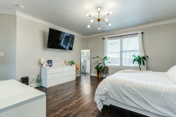 a room with a bed and a flat screen tv