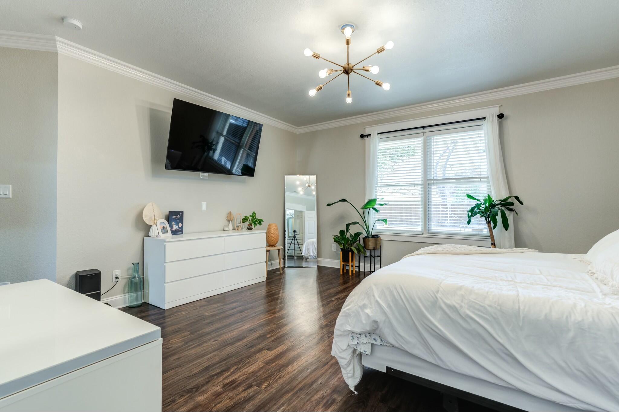 3219 22nd Street Lubbock, TX 79410 - Photo 24 of 51 a room with a bed and a flat screen tv