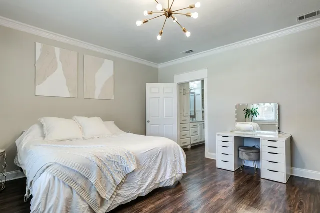 a bedroom with a bed and a desk