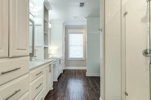 a bathroom with a double vanity sink a mirror and a shower