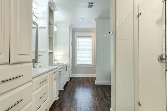 a bathroom with a double vanity sink a mirror and a shower