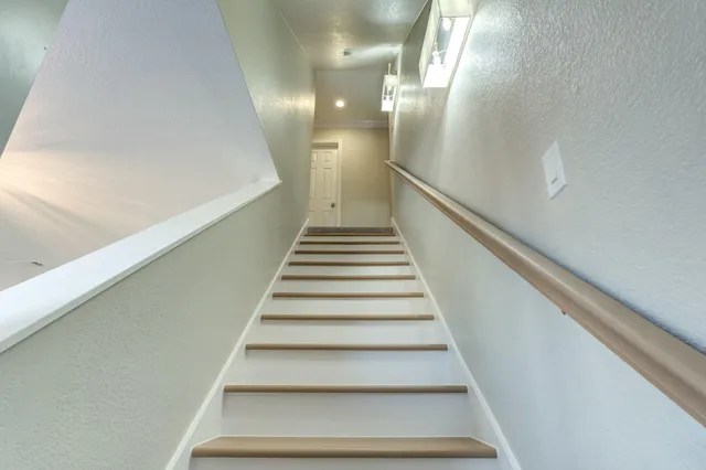 a spacious bedroom with a bed and a window