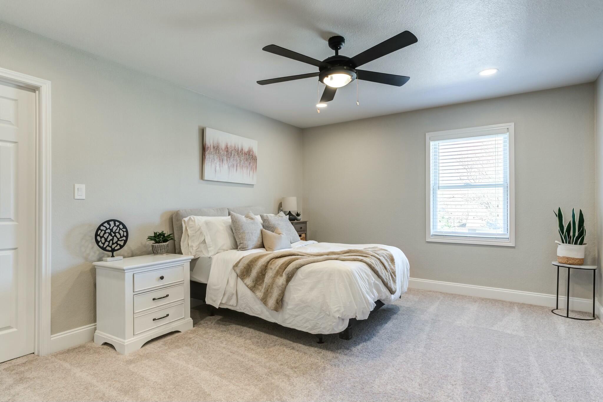 3219 22nd Street Lubbock, TX 79410 - Photo 33 of 51 a spacious bedroom with a bed and a window