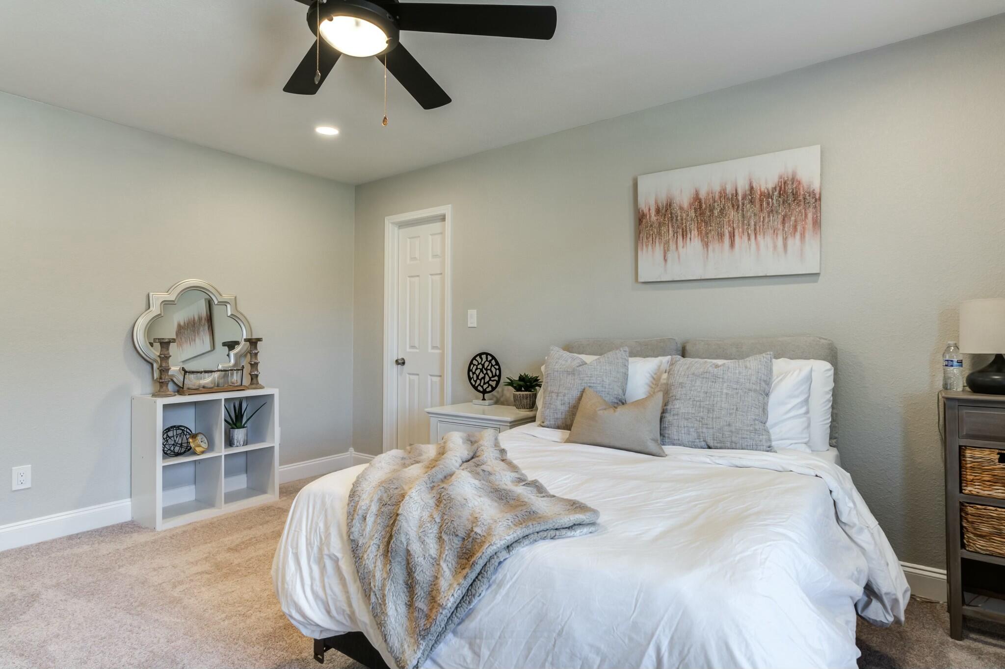 3219 22nd Street Lubbock, TX 79410 - Photo 34 of 51 a bedroom with a bed and a chandelier