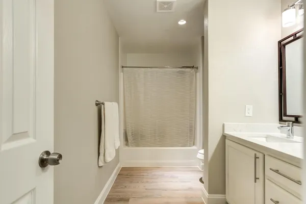 a bathroom with a double vanity sink and a bathtub