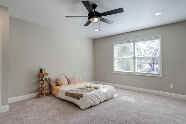a bedroom with a bed and window