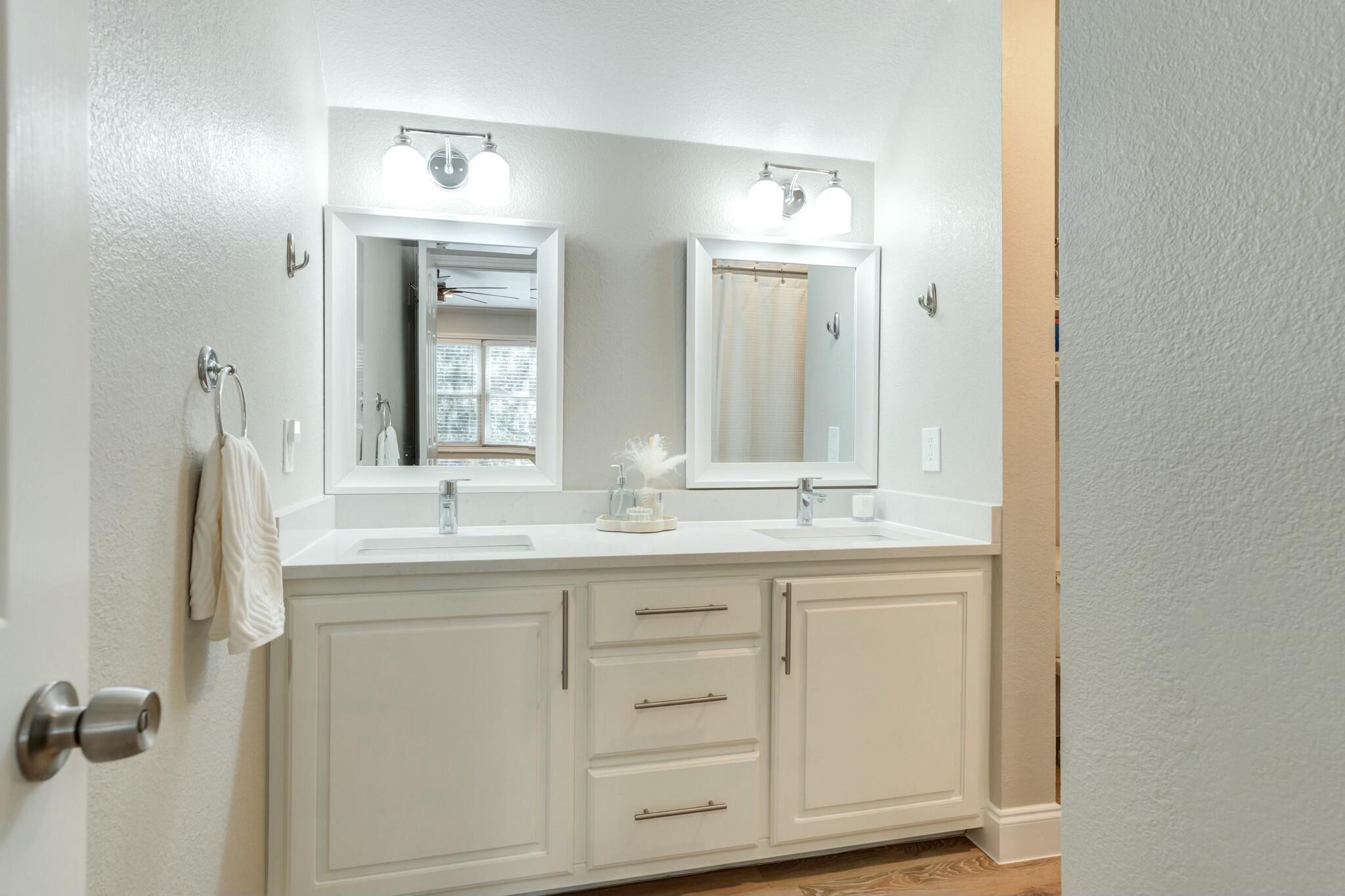 3219 22nd Street Lubbock, TX 79410 - Photo 45 of 51 a bathroom with a granite countertop sink and a mirror