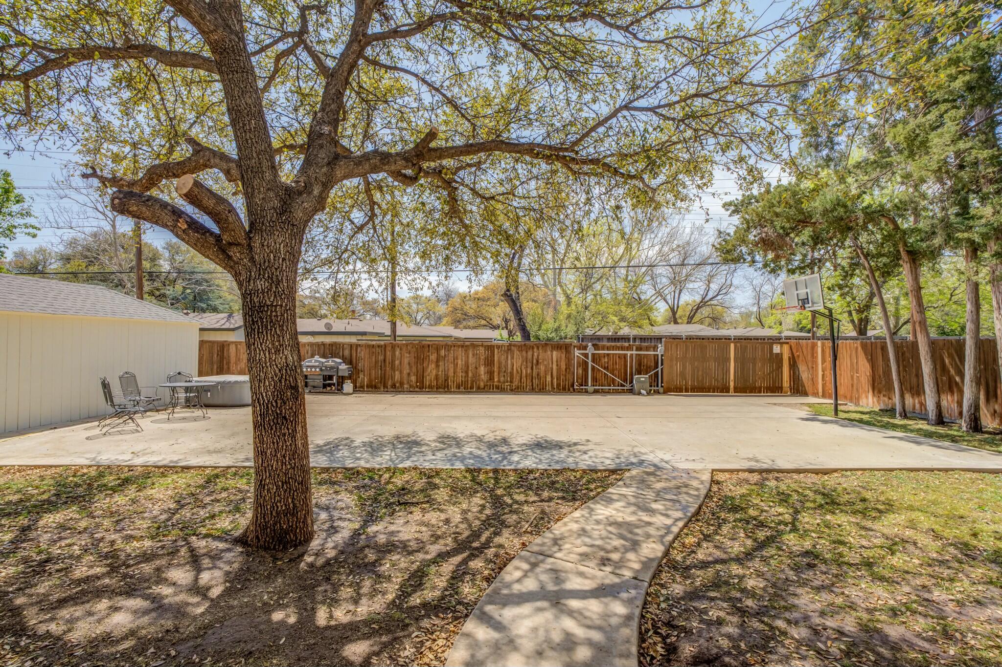 3219 22nd Street Lubbock, TX 79410 - Photo 47 of 51 a view of a yard with a tree