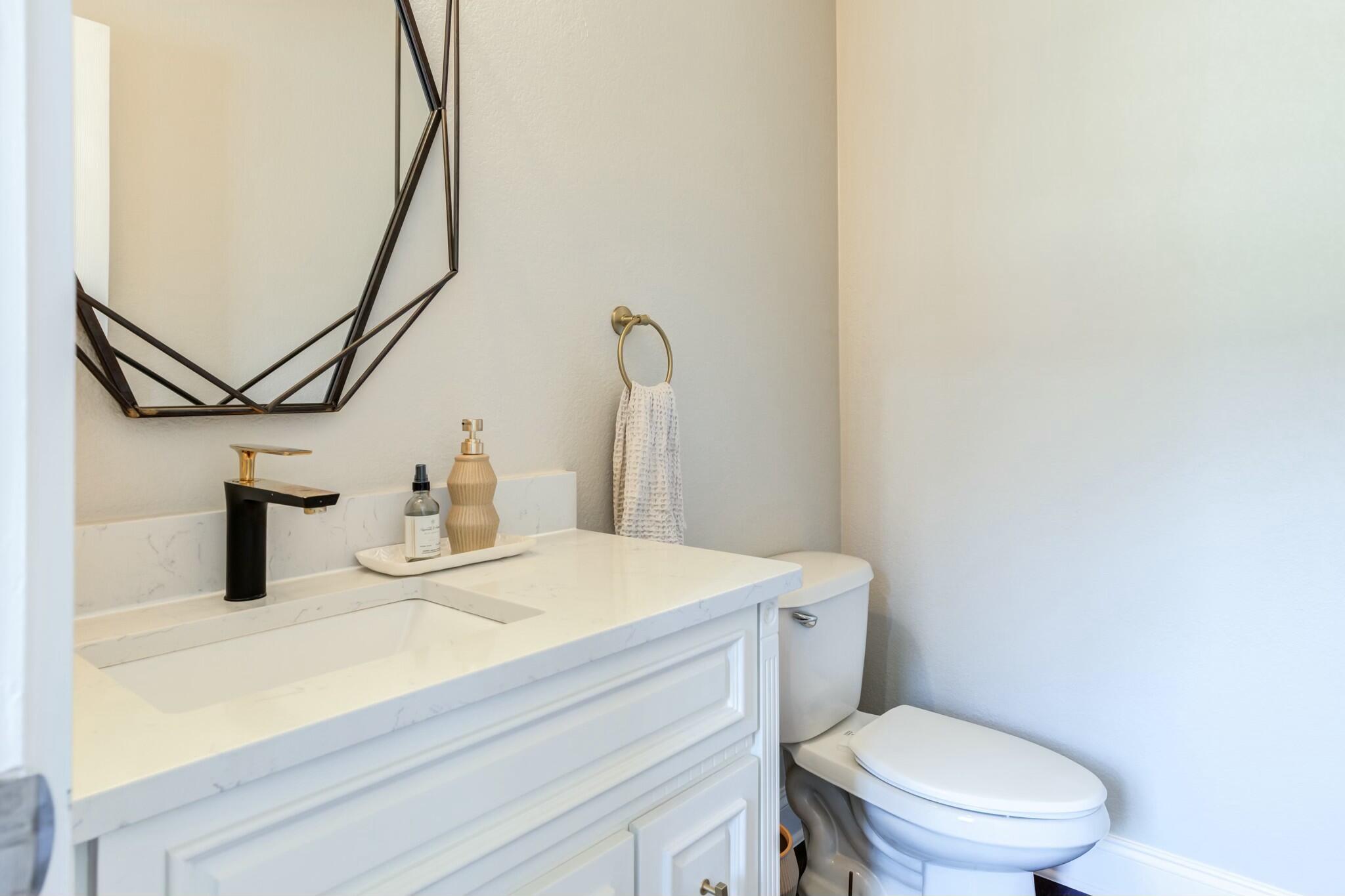 3219 22nd Street Lubbock, TX 79410 - Photo 5 of 51 a bathroom with a sink a toilet and mirror