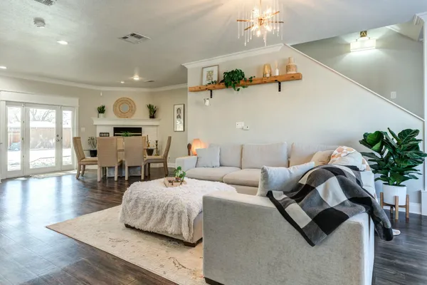 a living room with furniture and wooden floor