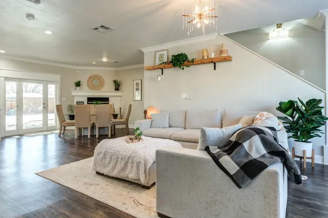 a living room with furniture and wooden floor