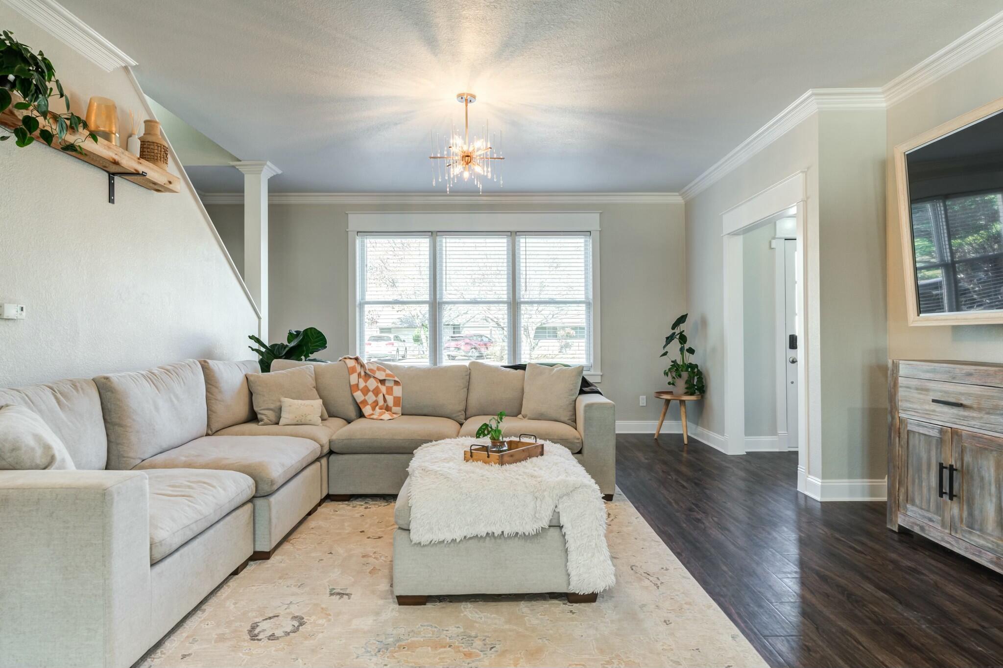 3219 22nd Street Lubbock, TX 79410 - Photo 7 of 51 a living room with furniture and a chandelier