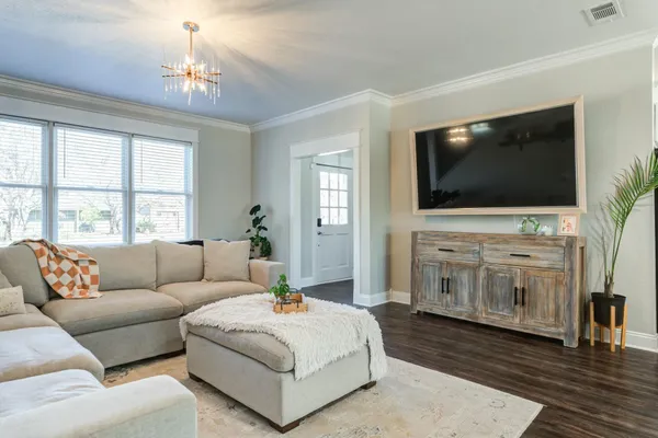 a living room with furniture and a flat screen tv