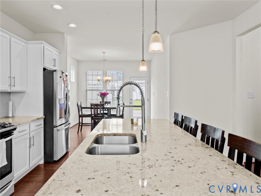 6135 Buntline Lane Richmond, VA 23234 - Photo 13 of 34 a kitchen with refrigerator a stove a sink and a refrigerator