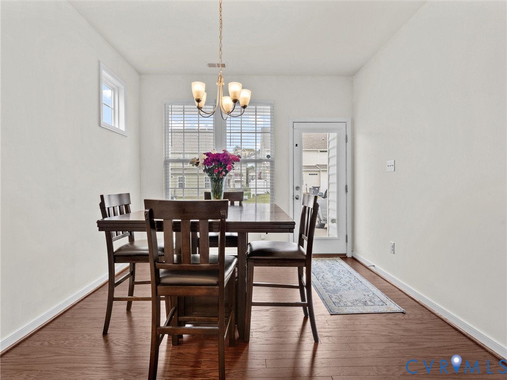 6135 Buntline Lane Richmond, VA 23234 - Photo 15 of 34 a view of a dining room with furniture and wooden floor