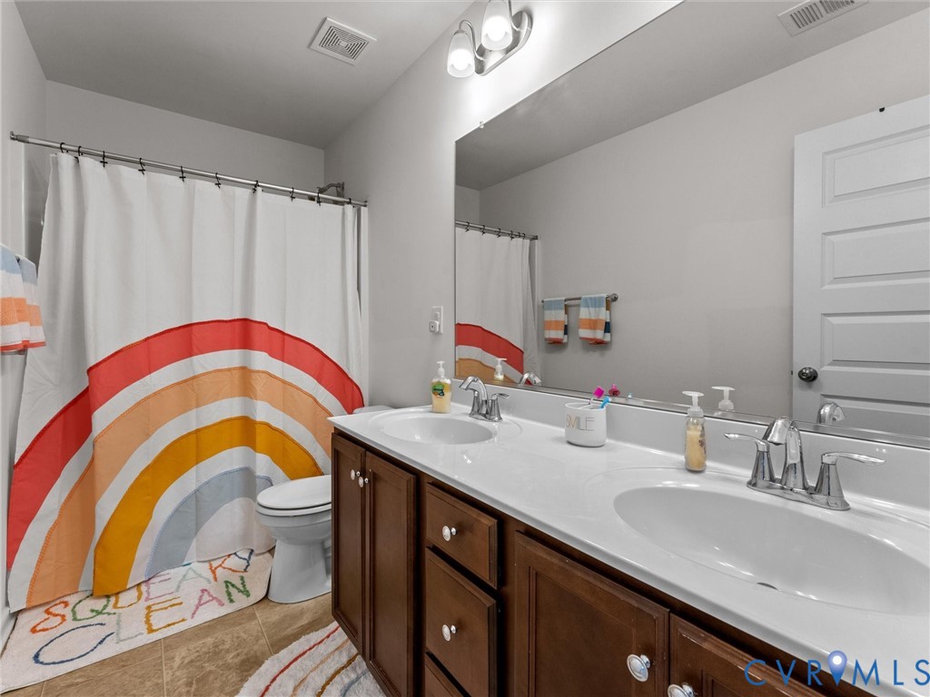 6135 Buntline Lane Richmond, VA 23234 - Photo 23 of 34 a bathroom with a sink vanity and a mirror