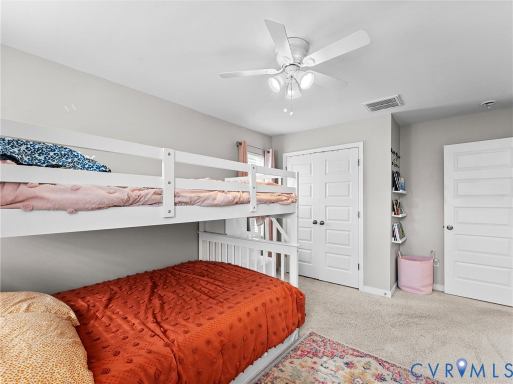 6135 Buntline Lane Richmond, VA 23234 - Photo 26 of 34 a bedroom with a bed and a chandelier