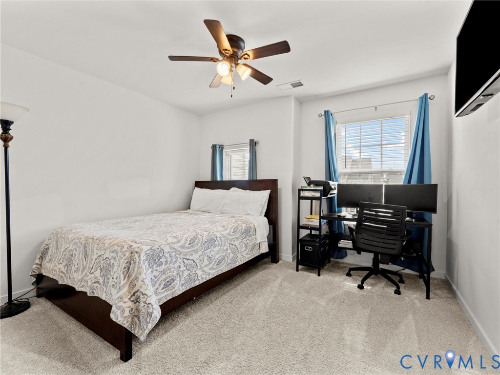 6135 Buntline Lane Richmond, VA 23234 - Photo 28 of 34 a bedroom with bed and a flat screen tv