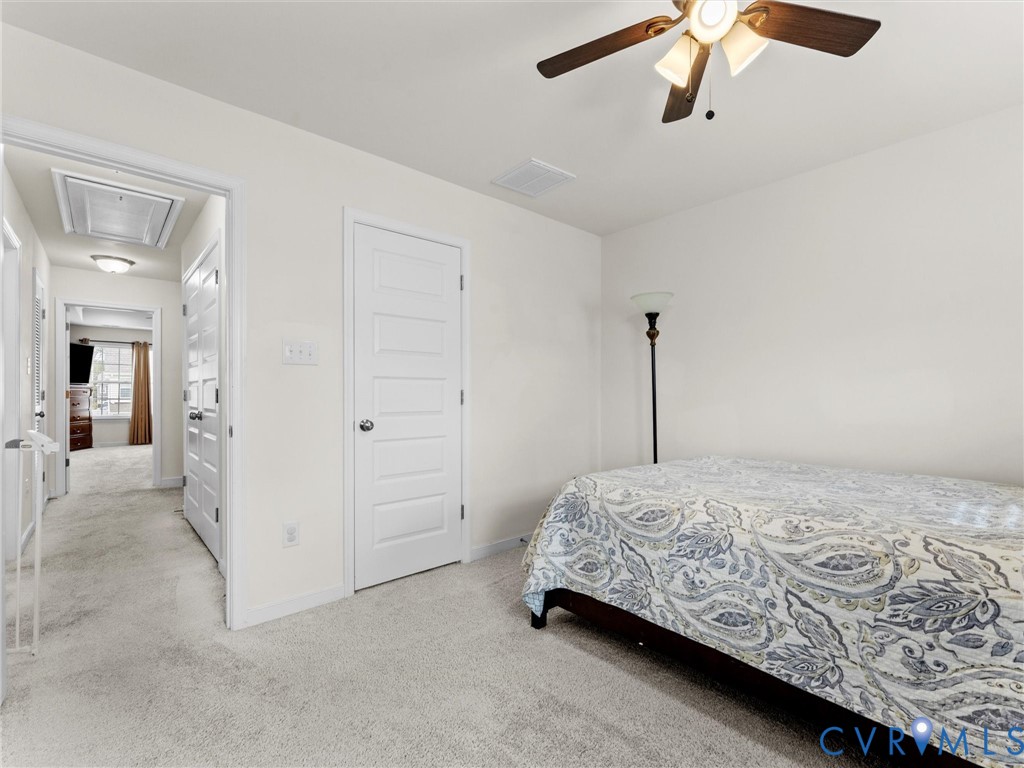 6135 Buntline Lane Richmond, VA 23234 - Photo 29 of 34 a bedroom with a bed and ceiling fan