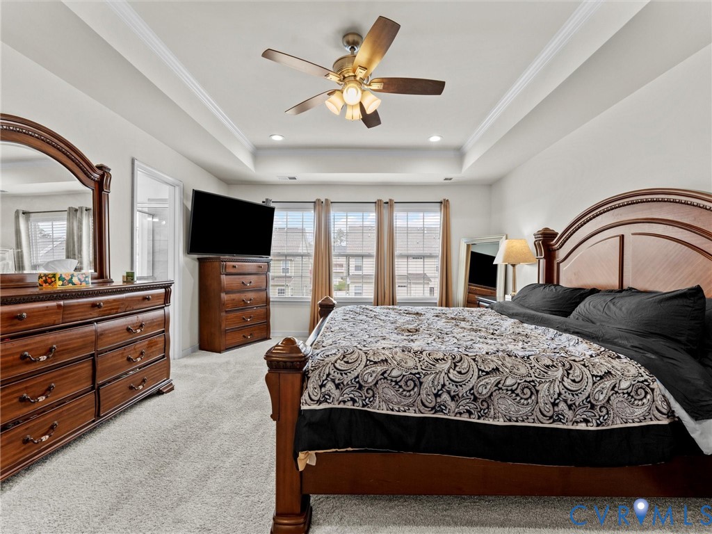 6135 Buntline Lane Richmond, VA 23234 - Photo 30 of 34 a bedroom with a large bed and a flat screen tv