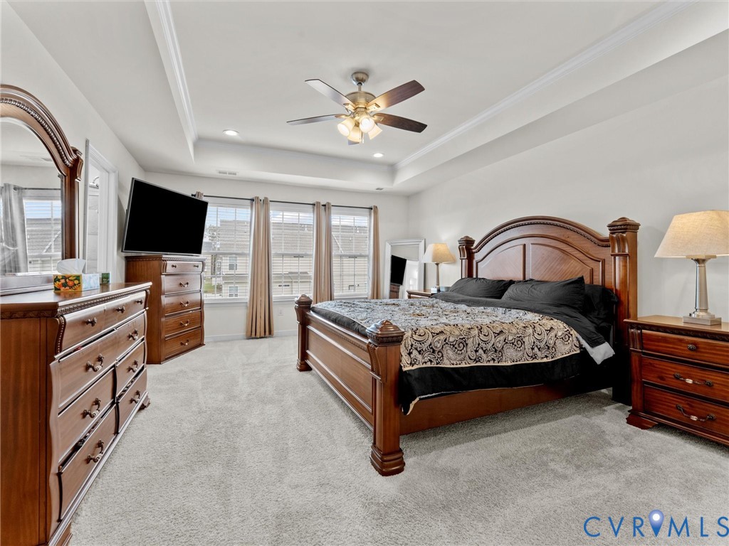 6135 Buntline Lane Richmond, VA 23234 - Photo 31 of 34 a bedroom with a large bed and a flat screen tv