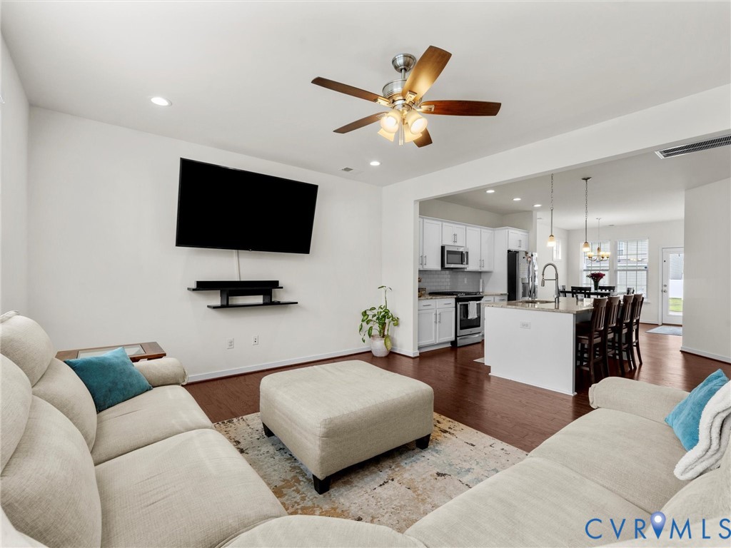 6135 Buntline Lane Richmond, VA 23234 - Photo 8 of 34 a living room with furniture and a flat screen tv