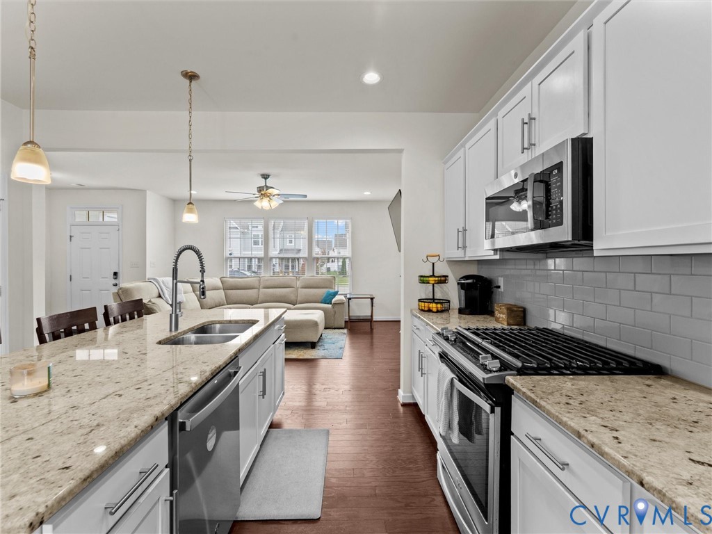 6135 Buntline Lane Richmond, VA 23234 - Photo 10 of 34 a kitchen with stainless steel appliances granite countertop a sink stove and cabinets