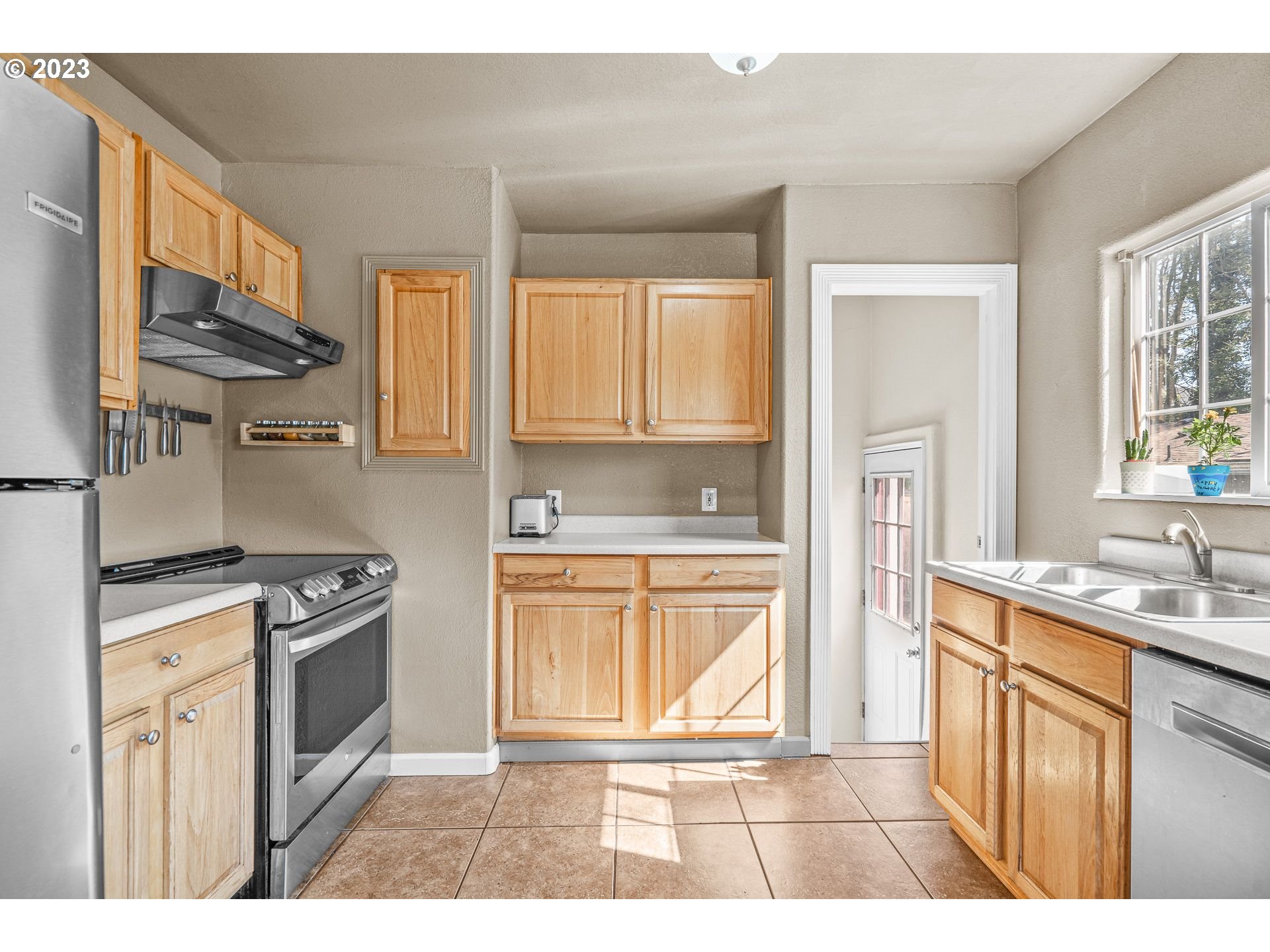 1255 North Kilpatrick Street Portland, OR 97217 - Photo 18 of 30 a kitchen with stainless steel appliances granite countertop a stove a sink and a refrigerator