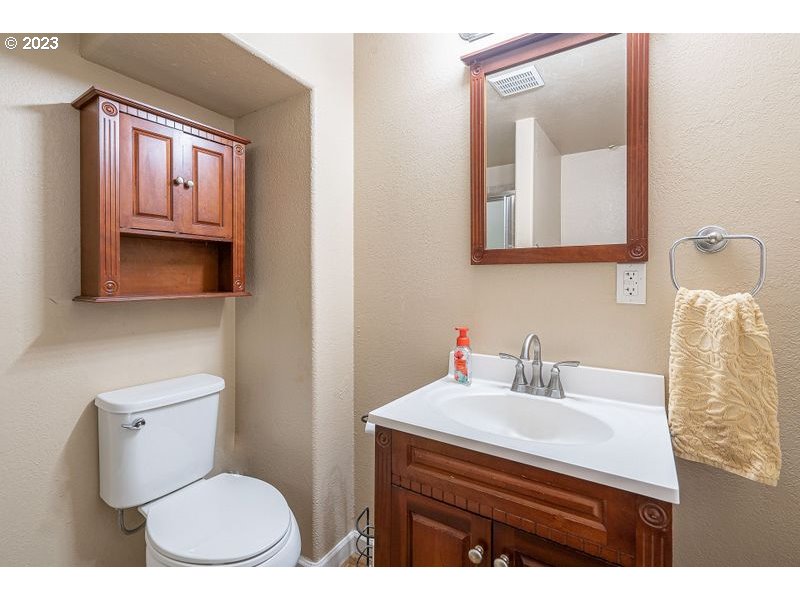 1255 North Kilpatrick Street Portland, OR 97217 - Photo 23 of 30 a bathroom with a sink mirror vanity and toilet