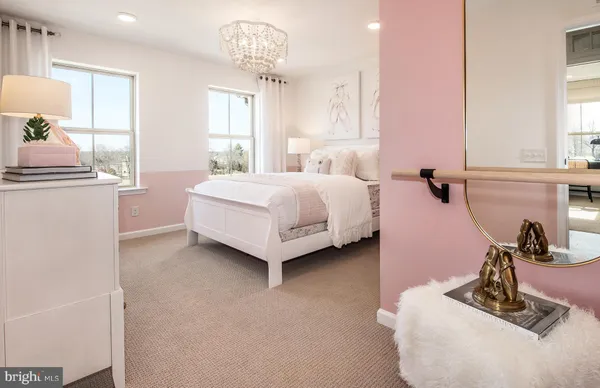 a spacious bedroom with a bed and a chandelier