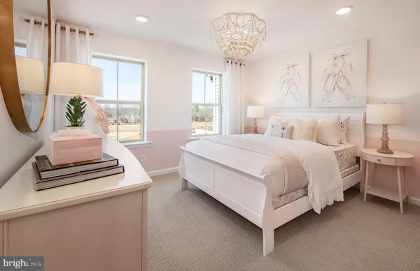 a bedroom with bed and a chandelier