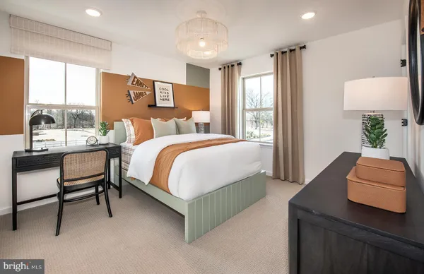 a bedroom with a bed and a couch