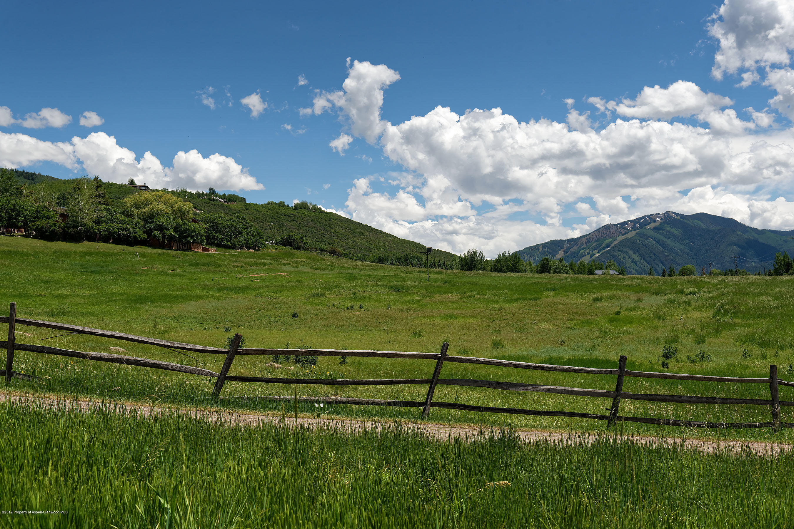 1765 McLain Flats Road Aspen, CO 81612 - Photo 12 of 73 a view of a golf course with a lake