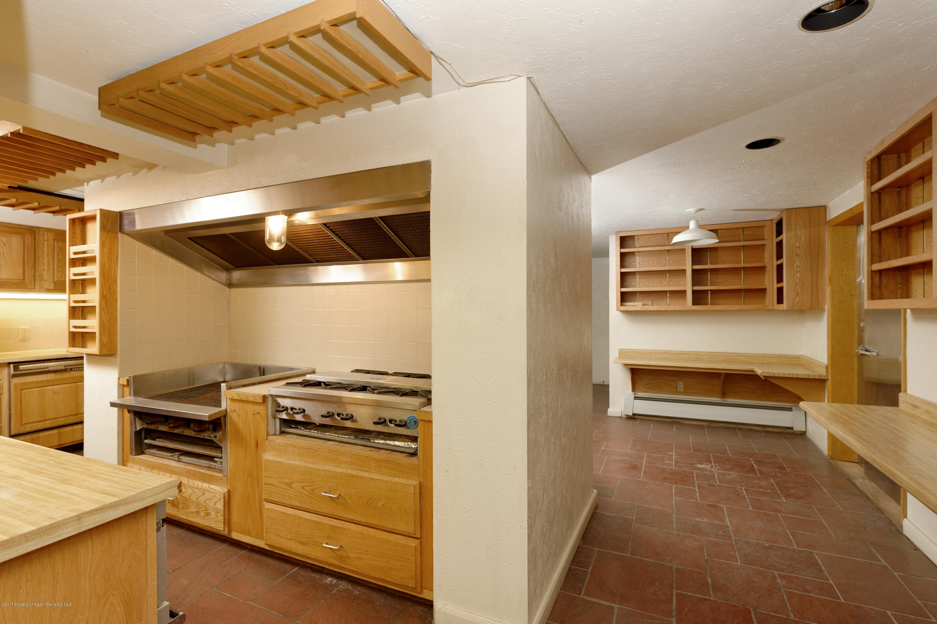 1765 McLain Flats Road Aspen, CO 81612 - Photo 58 of 73 a kitchen with granite countertop a stove and cabinets