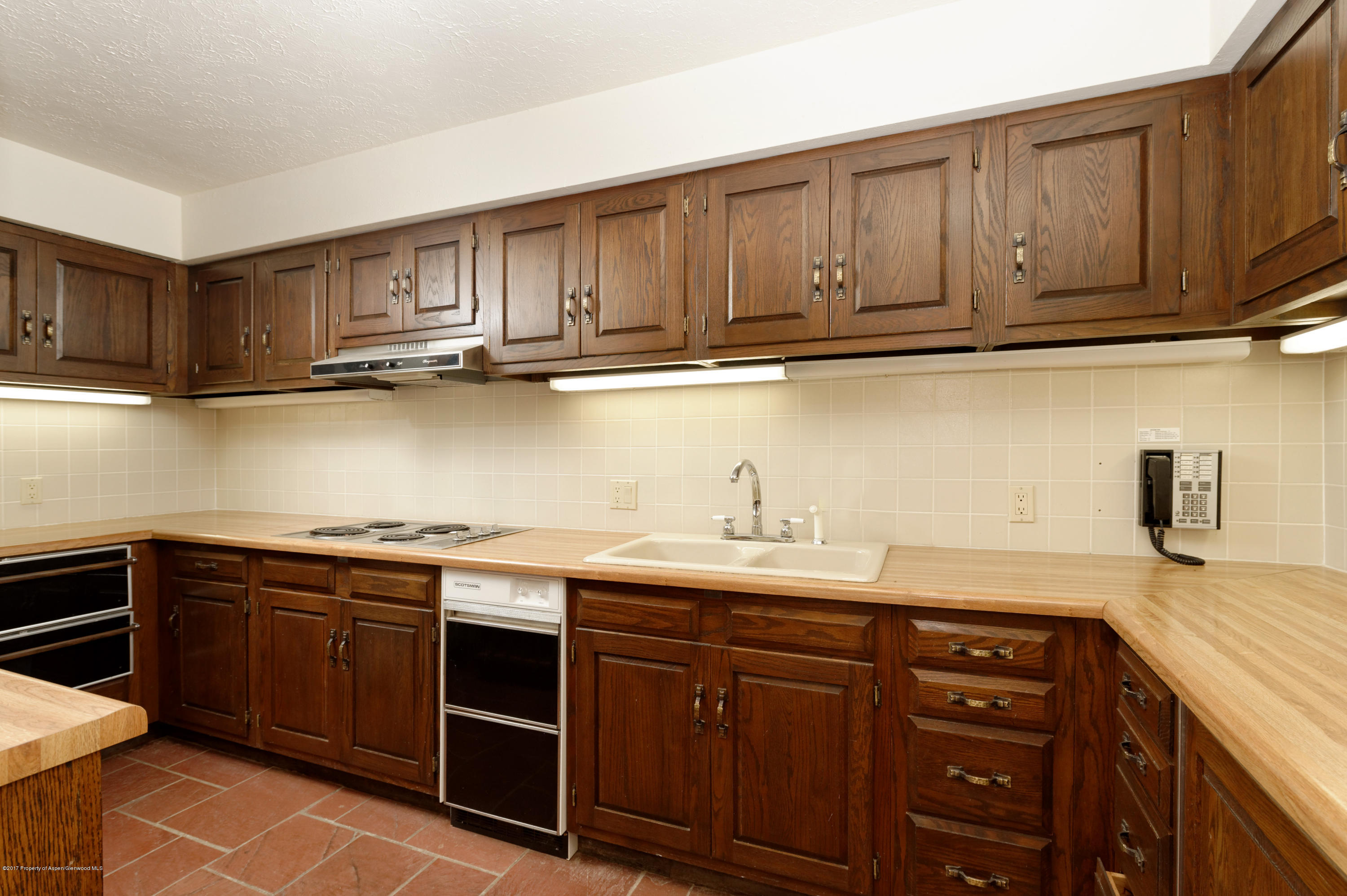 1765 McLain Flats Road Aspen, CO 81612 - Photo 60 of 73 a kitchen with stainless steel appliances granite countertop a sink dishwasher stove and cabinets with wooden floor