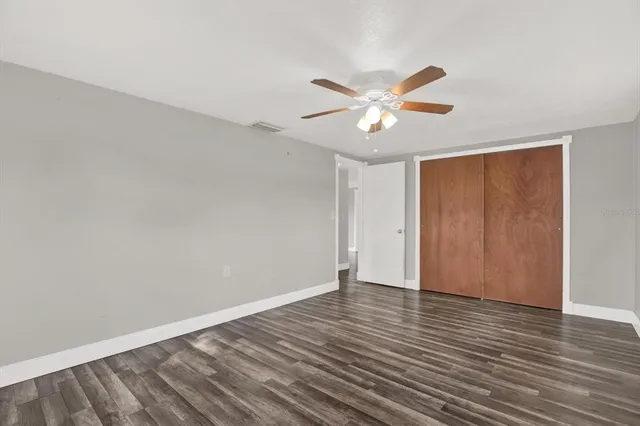 a view of an empty room with wooden floor