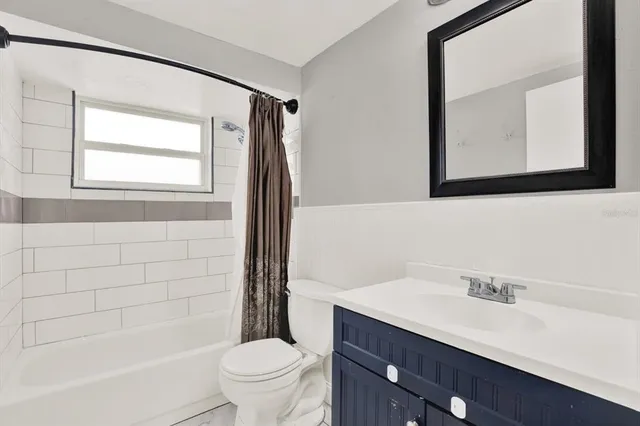 a bathroom with a bathtub a sink a toilet and a mirror