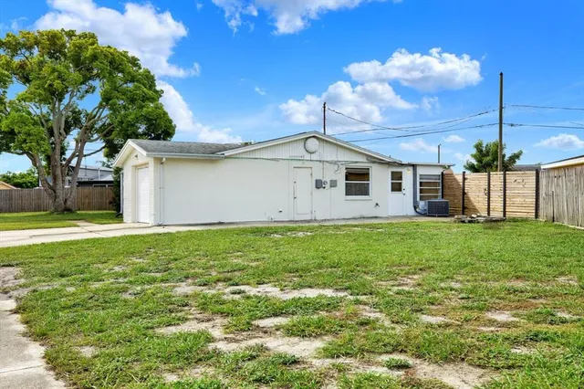 a tree in front of a white house