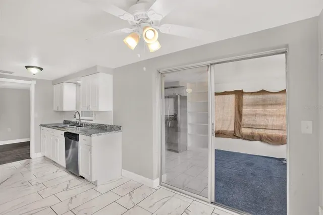 a kitchen with granite countertop a stove and a refrigerator