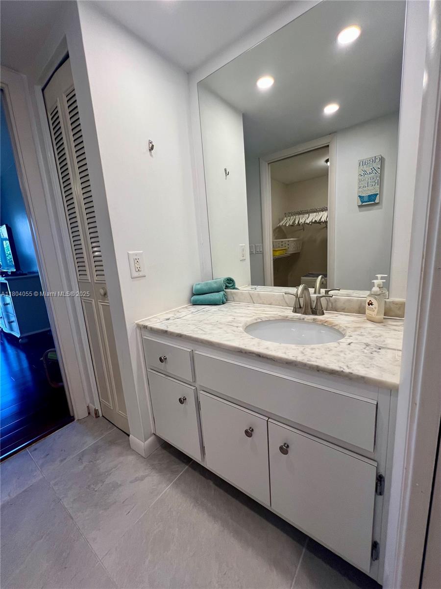 1481 South Ocean Boulevard, Unit 211E Lauderdale-by-the-Sea, FL 33062 - Photo 15 of 28 a bathroom with a double vanity sink and a mirror