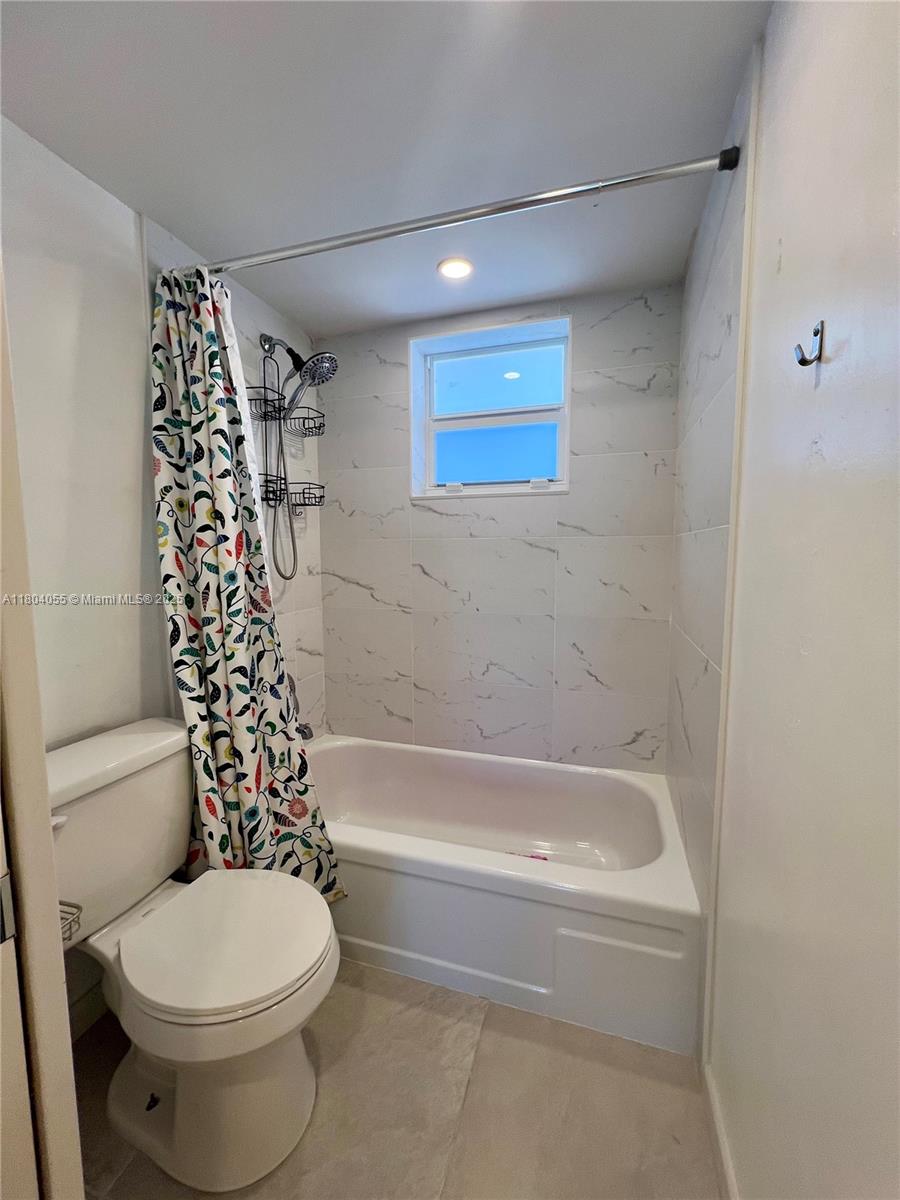 1481 South Ocean Boulevard, Unit 211E Lauderdale-by-the-Sea, FL 33062 - Photo 16 of 28 a bathroom with a toilet and a bathtub
