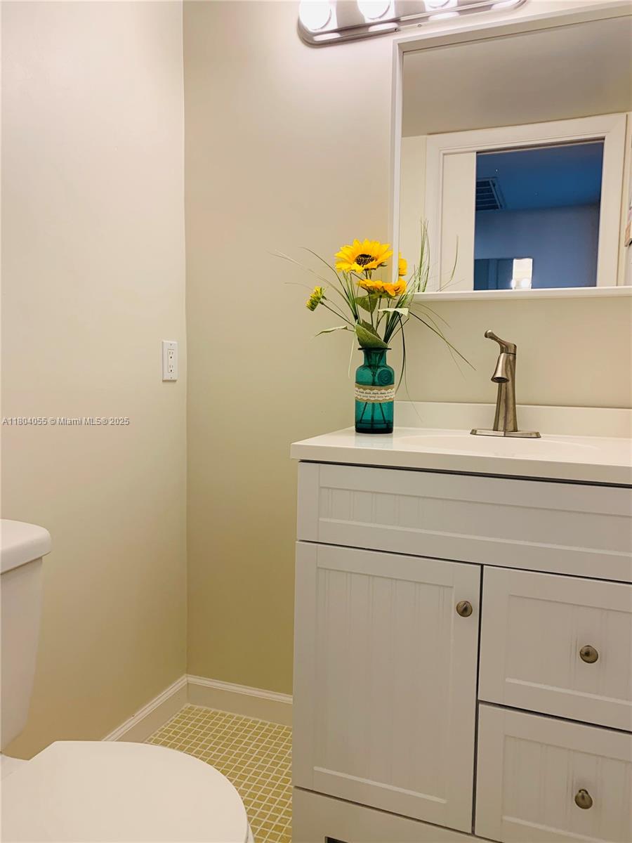 1481 South Ocean Boulevard, Unit 211E Lauderdale-by-the-Sea, FL 33062 - Photo 20 of 28 a bathroom with a sink and a mirror
