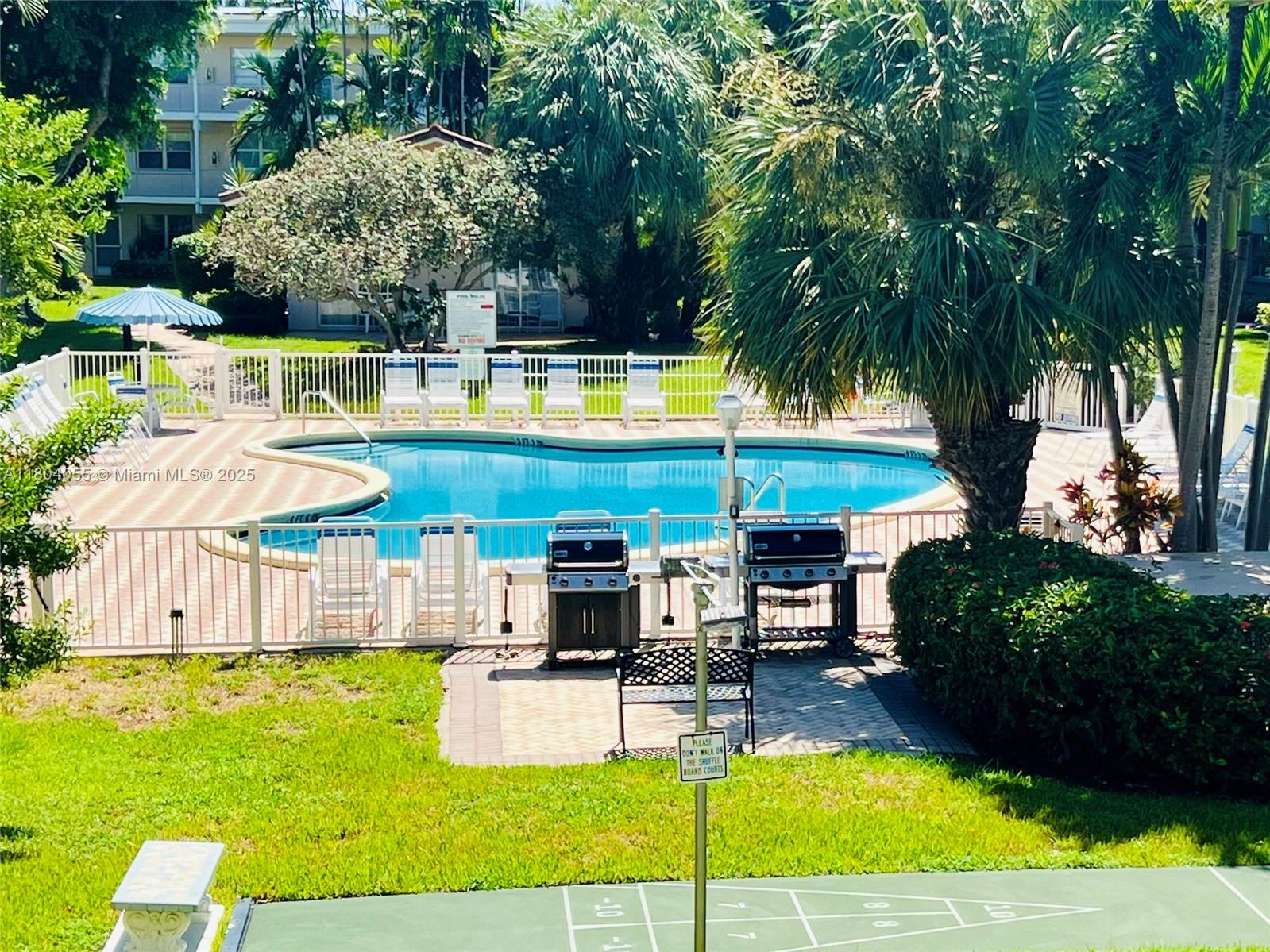 1481 South Ocean Boulevard, Unit 211E Lauderdale-by-the-Sea, FL 33062 - Photo 5 of 28 a view of a swimming pool with a patio