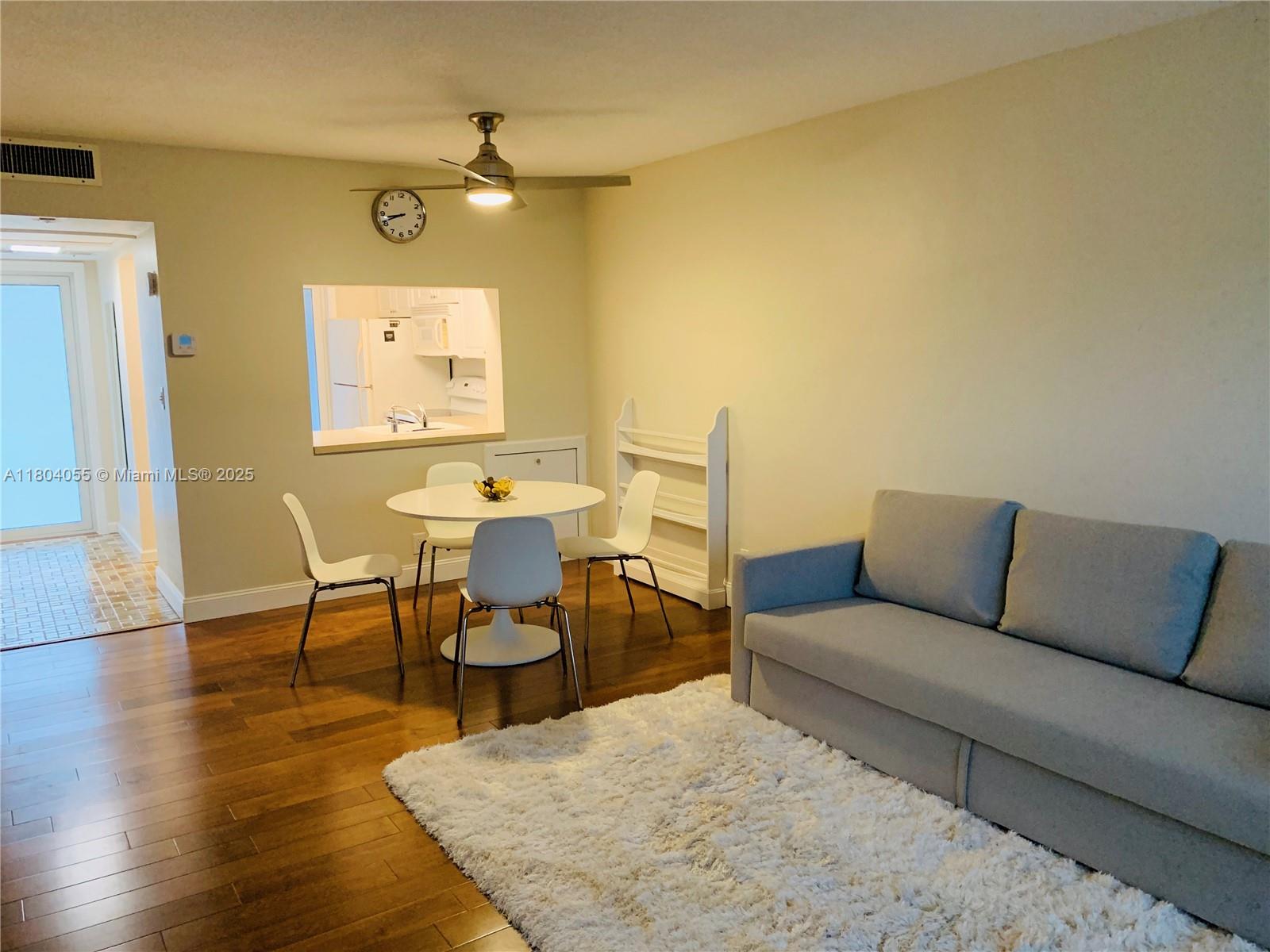 1481 South Ocean Boulevard, Unit 211E Lauderdale-by-the-Sea, FL 33062 - Photo 9 of 28 a living room with furniture and a table