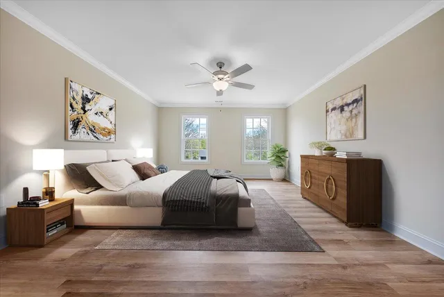a spacious bedroom with a large bed and a chandelier